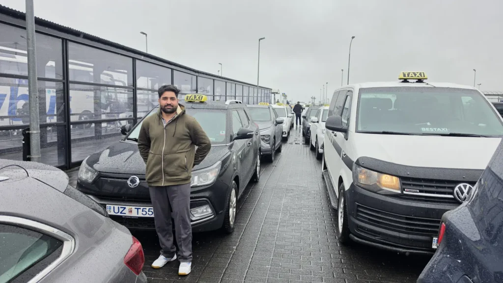 Cabicl driver and vehicle at Keflavík Airport